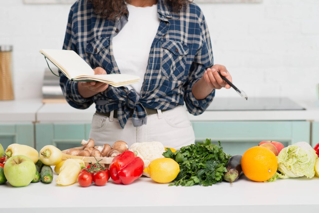 hands holding notebook vegetables