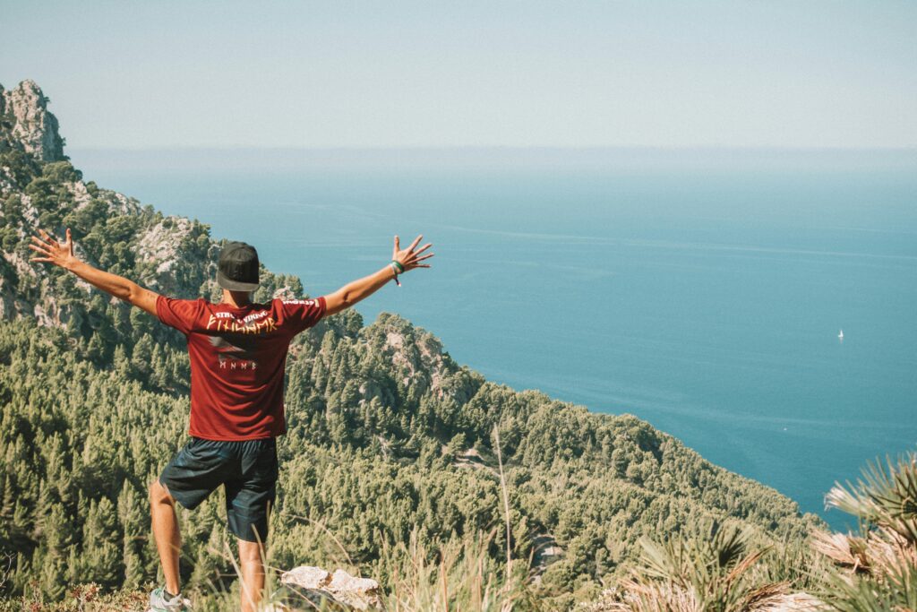 Man enjoys stunning view over the Mediterranean Sea from Mallorca, Spain, a perfect adventure escape.